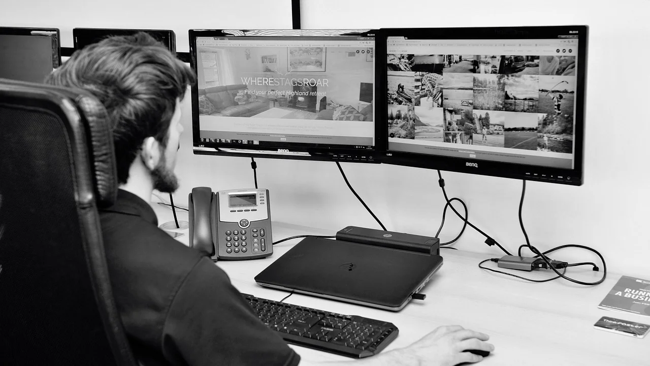Espaço de trabalho organizado com notebook e monitores externos