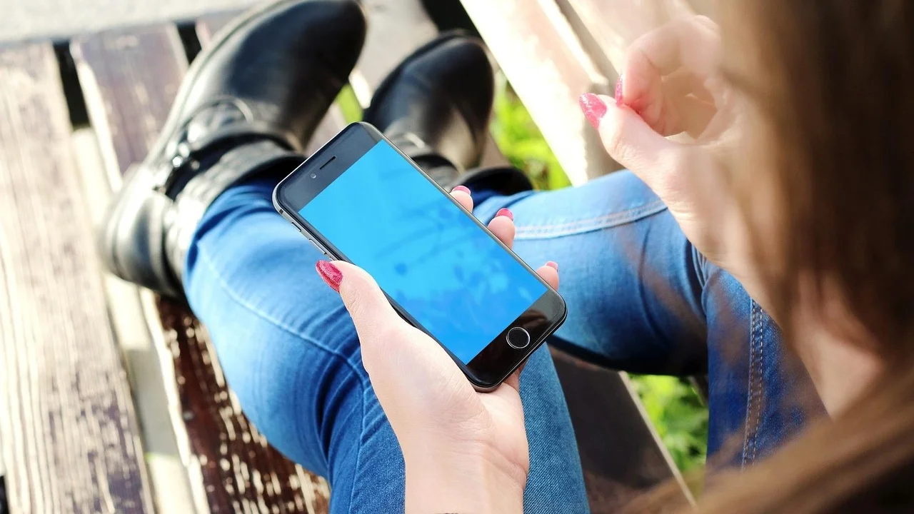 Pessoa usa o celular enquanto observa publicações em uma rede social.